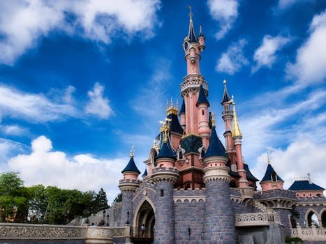 pexels-photo-30560377-30560377-1 Magical view of the iconic Disneyland Paris castle with a vibrant blue sky.